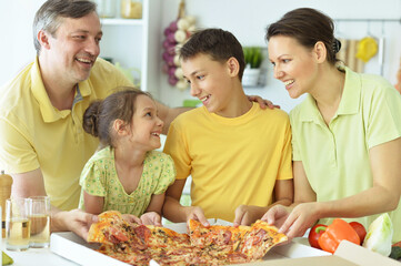 Portrait of big happy family eating pizza together