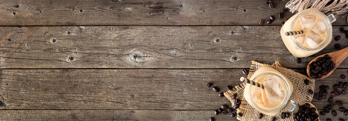 Cold iced coffee corner border over a rustic dark wood banner background with copy space