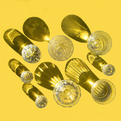 Glasses with clear water stand on a yellow background, top view. Beautiful creative still life is...