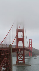 Topless - The iconic Golden Gate Bridge disappears into the famous San Francisco fog. San Francisco, California, USA. 