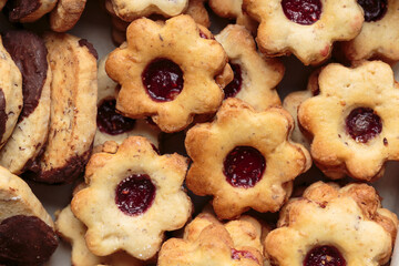 Top view of box full of unstyled German Christmas cookies baked in traditional home-made style of grandma. Horizontal close-up.
