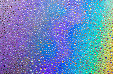 Background of water drops on gradient colorful surface.