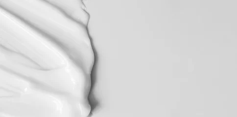 Poster Close-up cream moisturiser smear smudge wavy texture on white background with copy space horizontal banner format. Skin care beauty product © Olha Kozachenko