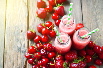 Summer smoothies background with red berries.
