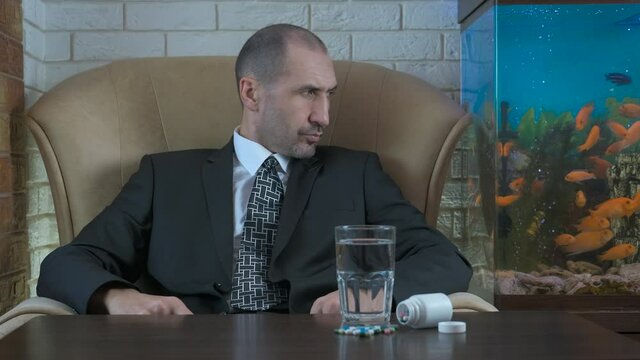 Business and antidepressants. A man in a business suit with antidepressant pills.