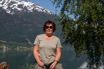 Fototapeta premium woman stands by beautiful mountains in norway