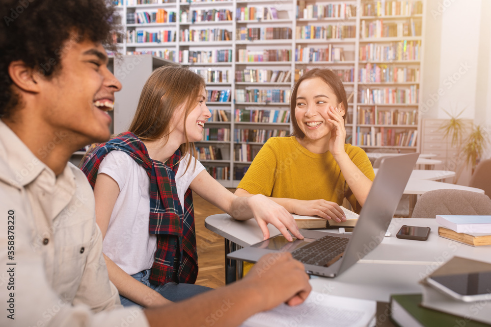 Poster university students are studying in a library together. concept of teamwork and preparation