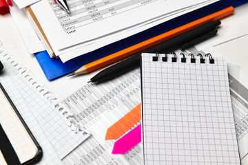 Top view of office employee's desk - work with financial reports, analysis and accounting, tables and graphs, various office items for bookkeeping