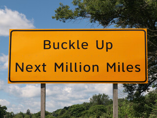 Buckle up seat belt next million miles highway safety sign.