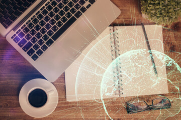Social network hologram drawings over computer on the desktop background. Top view. Double exposure.