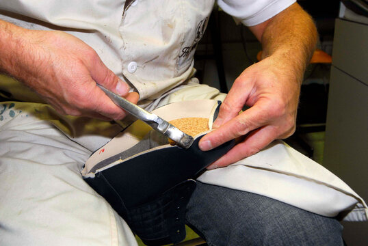 orthopedic shoemaker at his workshop