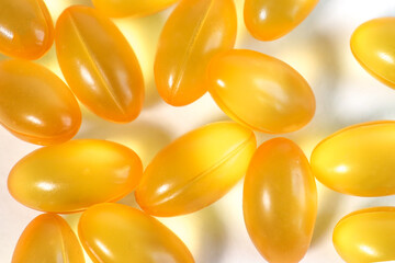 Omega 3 gold fish oil capsules, Vitamins supplements pills omega 3. Cod liver oil medicines on wooden table. Fish oil capsules.