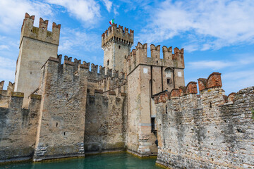 Rocca Scaligera castle in Sirmione with blue cloudy sky on the background