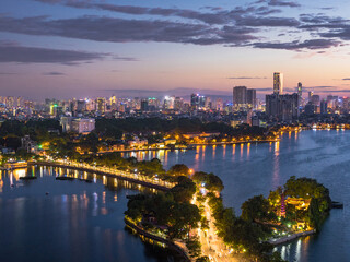 Fototapeta premium Aerial view of Hanoi skyline showing West Lake and Tay Ho District at dusk in Hanoi, Vietnam.