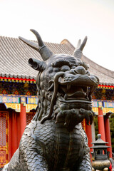 Fototapeta na wymiar It's Bronze qilin statue at the Hall of Benevolence and Longevity at the Summer Palace complex, an Imperial Garden in Beijing. UNESCO World Heritage.