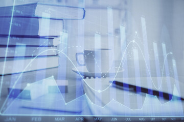 Double exposure of financial chart drawing and desktop with coffee and items on table background. Concept of forex market trading