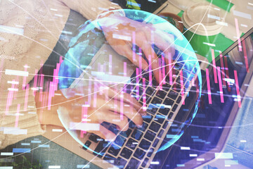 Double exposure of woman hands typing on computer and forex chart hologram drawing. Stock market invest concept.