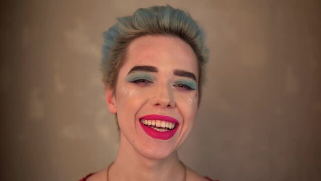 happy smiling gay man with make up travesti diva transvestite blue hair