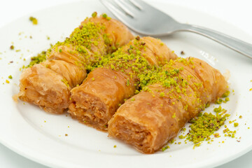 Three slices of Turkish baklava on a white plate, close up