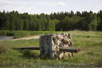 telegraph pole fallen in the forest on the sandy shore of the lake. The layers of the foundation laid for him are visible