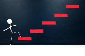 Ladder to success concept. Stick man taking first step on a red staircase.