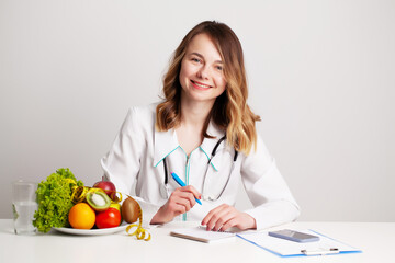 Nutritionist makes a diet plan for proper nutrition for the patient in his office