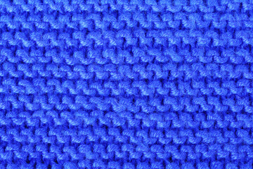 Texture pattern, knitted material from blue acrylic threads close-up