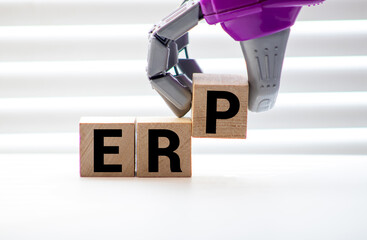 ERP Enterprise Resource Planning written on a wooden cube in a office desk