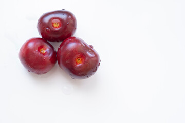 3 fresh cherries over a white background