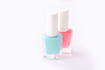 Nail polishes of different colors on white background