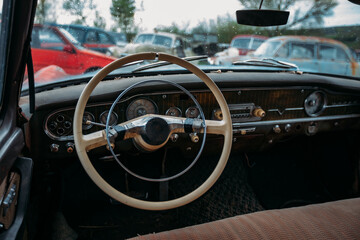 Retro car Interior. Steering wheel of abandoned rusty old car