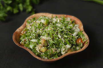 Tabbouleh: arabic salad in wooden bowl