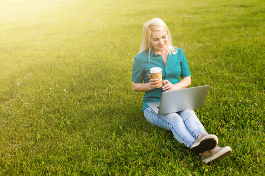 woman searching job with a laptop in an urban park in summer
