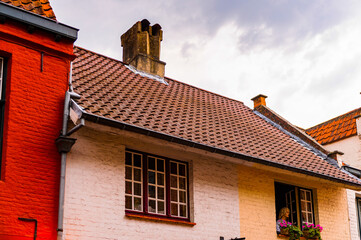 It's Medieval houses with flowers at the windows in the Historic Centre of Bruges, Belgium. part of the UNESCO World Heritage site