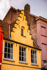 It's Medieval houses with flowers at the windows in the Historic Centre of Bruges, Belgium. part of the UNESCO World Heritage site