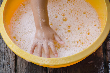 Child washing hands with soap to prevent virus and bacteria for corona virus (covid19) protection.