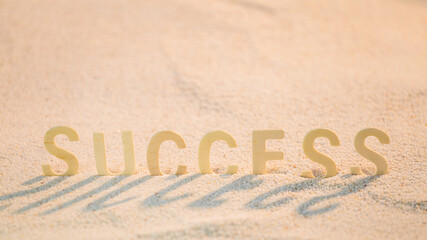 Success - Concept for Business Motivation with Wooden alphabet put on the sand beach.  Inspirational quote. Motivational words