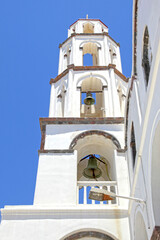 An arched bell tower in the traditional village of Megalochori in Santorini, Greece.