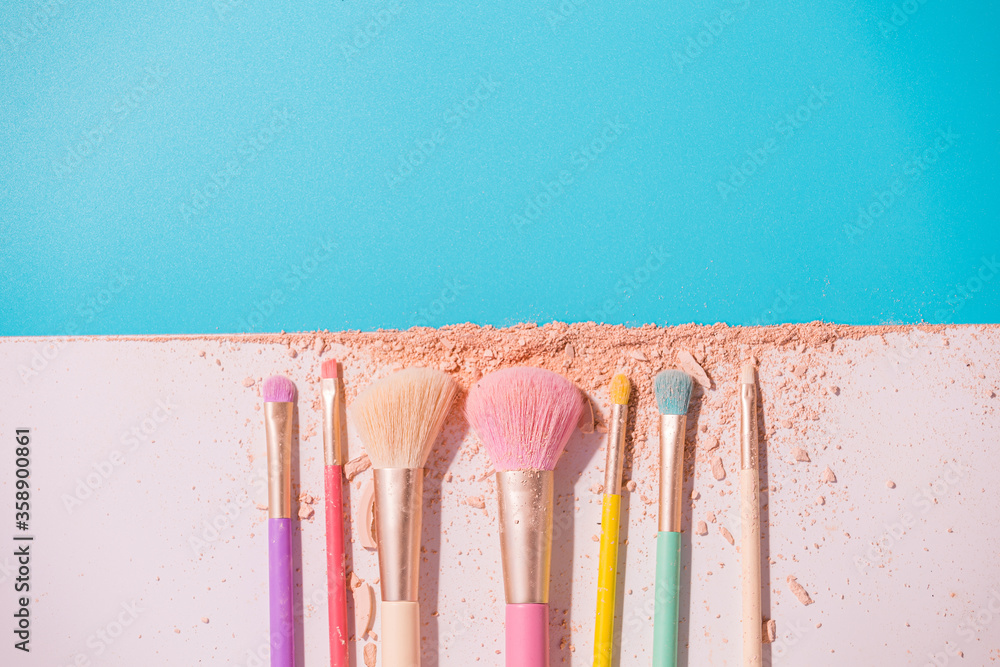 Wall mural make up brushes with powder on white and blue background