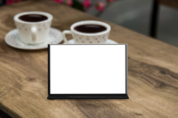 Obraz na płótnie Canvas Mockup blank menu frame on table in restuarant