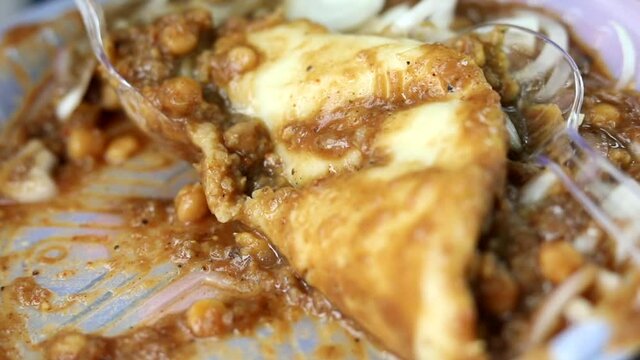 Fried Indian bread kulcha dipped in chana chole.