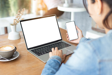 computer,cell phone mockup image.hand woman work using laptop texting mobile.blank screen with...
