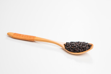 Black wild rice in a wooden spoon