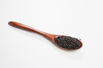 Black wild rice in a wooden spoon