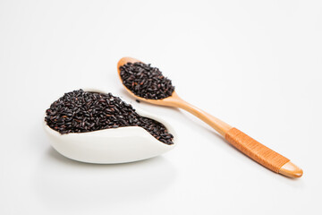Black wild rice in a wooden spoon