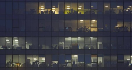 Timelapse people working late in corporate building at night - Powered by Adobe