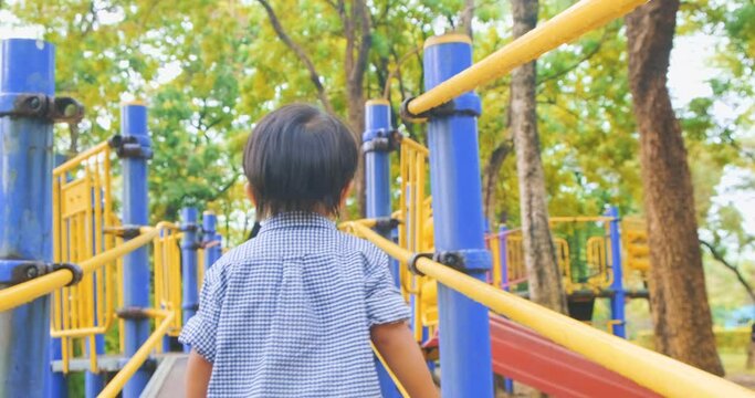 Adorable little boy playing on colorful playground toy outdoor park sport recreation activity