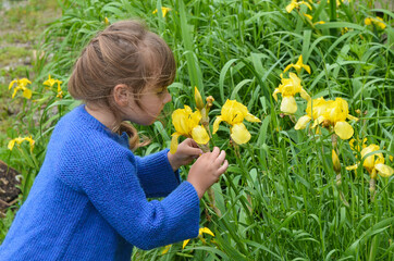caucasian girl playing with flowers in nature