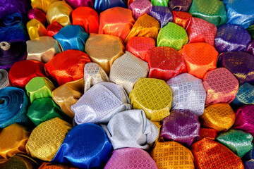 Top view and colorful of Saree fabrics fit to screen background and textured. Saree fabrics is Traditional indian women dress Used as both the garment and the blanket.