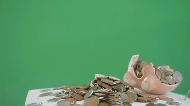 Slow motion hammer crush the piggy bank box full with coins